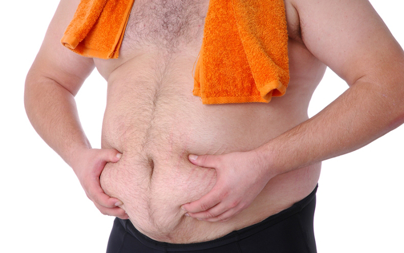 Fat man checking fat belly with towel